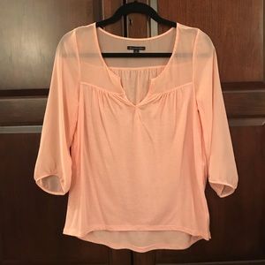 Peach colored top with sheer sleeves